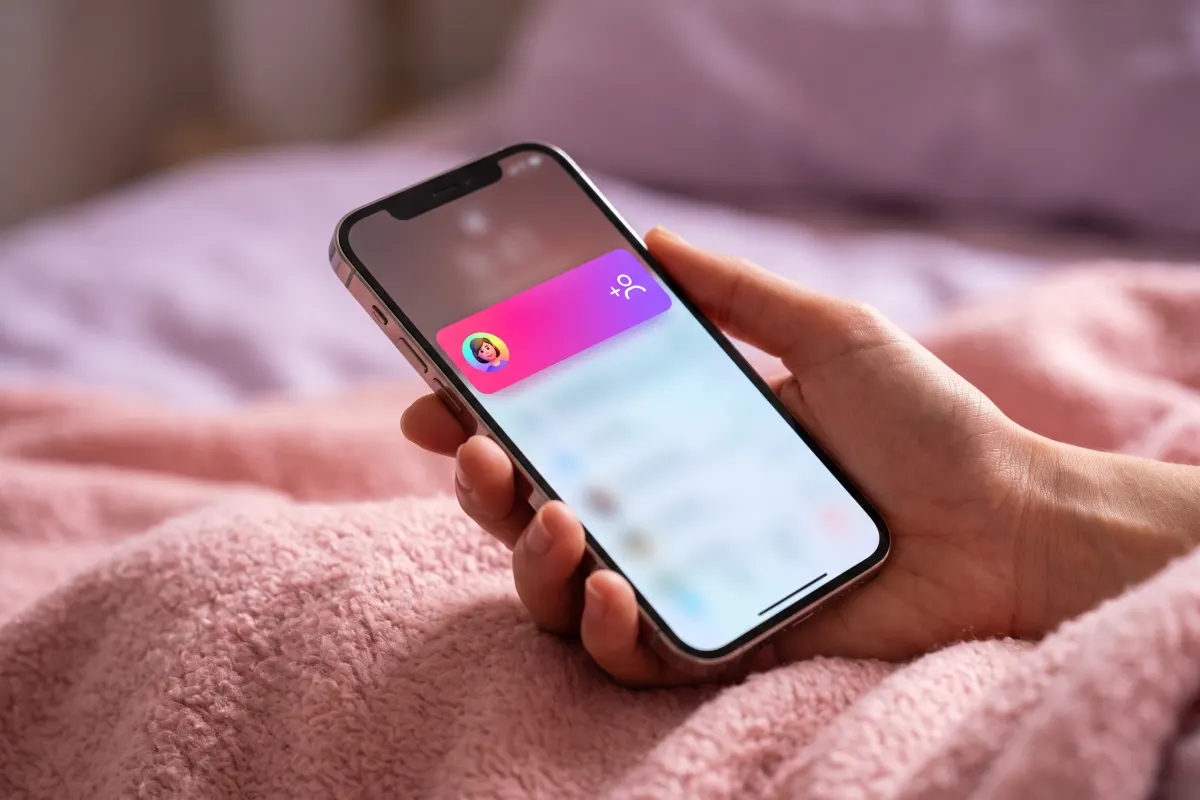 Hand holding a phone as a new-follow alert slides in from the top of the screen